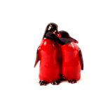 A pair of Royal Doulton Flambe penguin figurines,