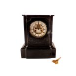 A slate mantel clock with key