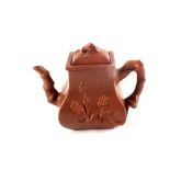 A Yixing teapot with relief floral decoration,