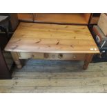 A large pine coffee table with three drawers below