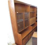 A 1970's style Nathan teak glazed bookcase with two door cupboard base below and a Nathan teak