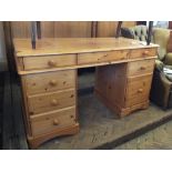 A modern pine eight drawer desk