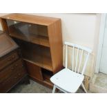 A modern glazed bookcase with cupboard below,