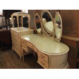 A cream and gilt painted French style bedroom suite comprising a chest of five drawers,