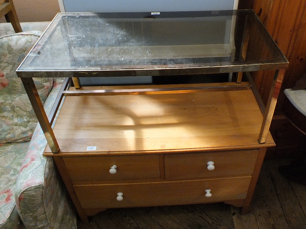 A satinwood chest of two short and long drawer with ceramic handles and a glass and metal