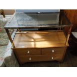 A satinwood chest of two short and long drawer with ceramic handles and a glass and metal