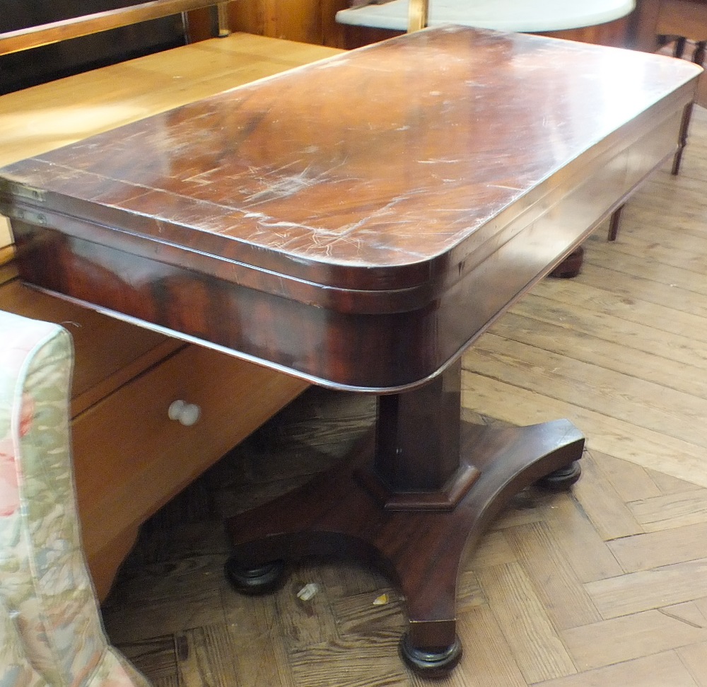 A Victorian mahogany card table on hexagonal column quatrefoil base