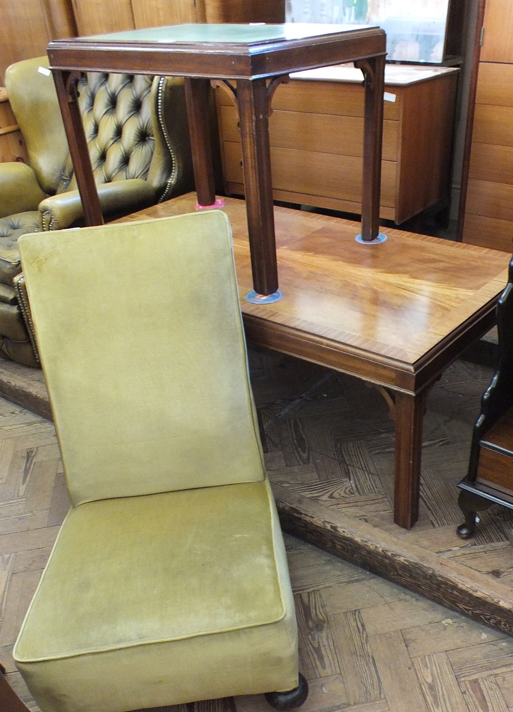 A gold upholstered low chair,