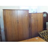 A large two door wardrobe with smaller two door matching wardrobe on legs