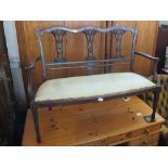 An Edwardian inlaid mahogany salon two seater sofa with cream upholstery