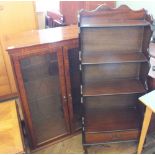 A modern two door glazed display cabinet and bookcase with four graduated shelves and back