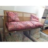 A gold painted rattan two seater sofa