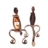 A pair of Arts and Crafts copper and wrought iron fire dogs with scrolled feet,