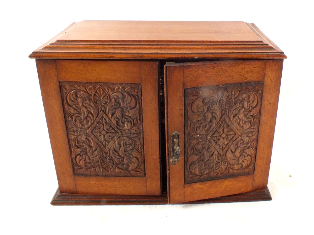 A Victorian oak smokers cabinet with pipes,