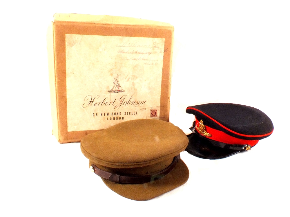 Two military caps, one with Royal Artillery badge in original box,