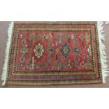 An Egyptian red ground geometric rug,