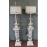 A pair of metal table lamps on floral pottery stands