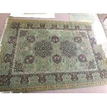 A green and floral Persian pattern carpet,