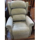 A nearly new pale green upholstered electric reclining armchair