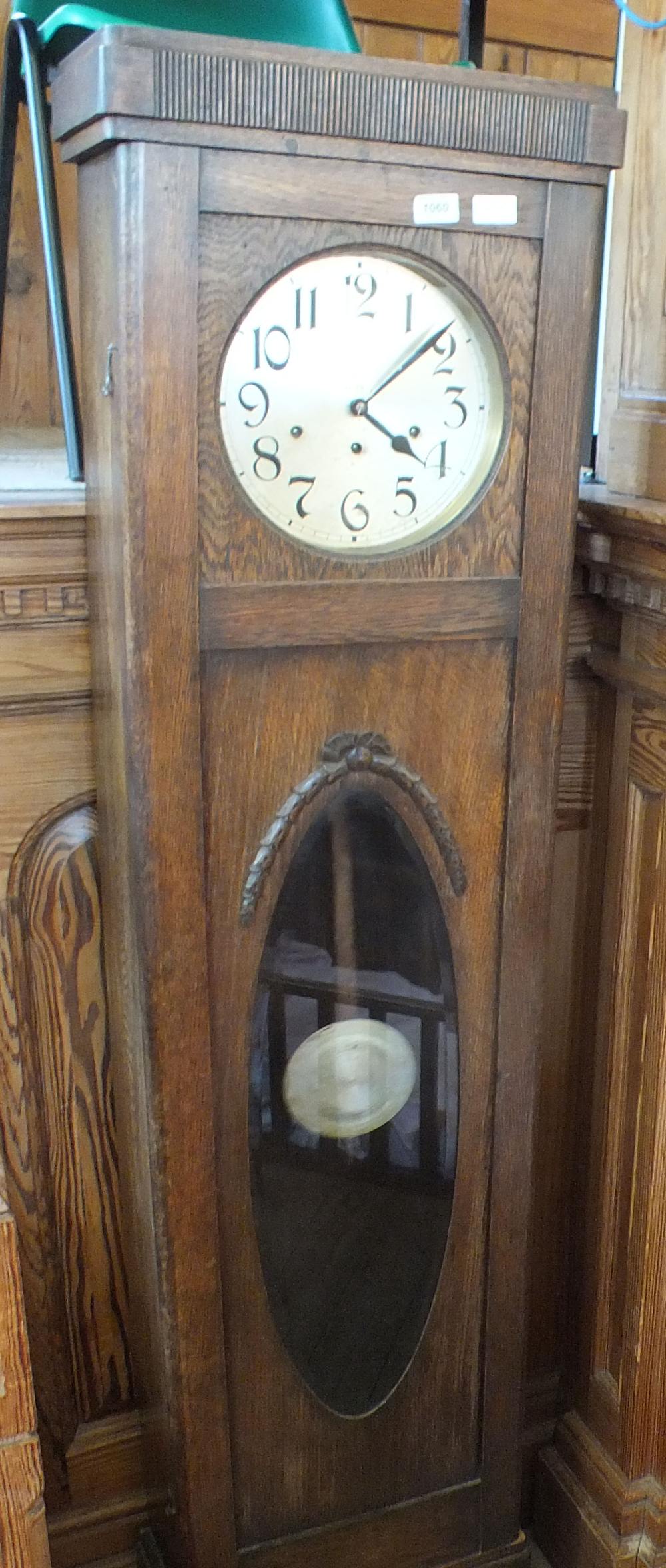 A 1920's eight day oak long case clock