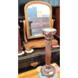 A Victorian mahogany swing toilet mirror and a large mahogany turned and reeded candlestick