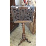 A Victorian mahogany double sided music stand with carved fretwork on tripod base