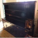 A substantial dark stained pine open back dresser with five drawers and five cupboards,
