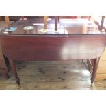 A 19th Century mahogany drop leaf dining table with one drawer and one faux drawer,