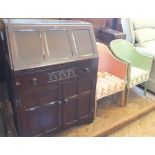 A Jentique bureau with single drawer and two door cupboard below and two loom style chairs,