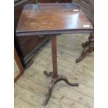 A 19th Century mahogany lift top music stand on tripod base