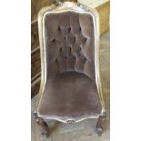 A Victorian nursing chair with walnut frame and decorative carving