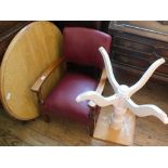 An oak frame elbow chair with red leatherette upholstery