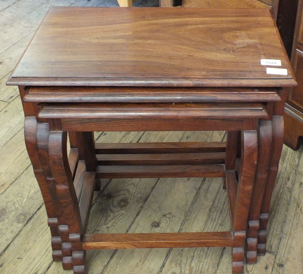 A nest of three hardwood tables