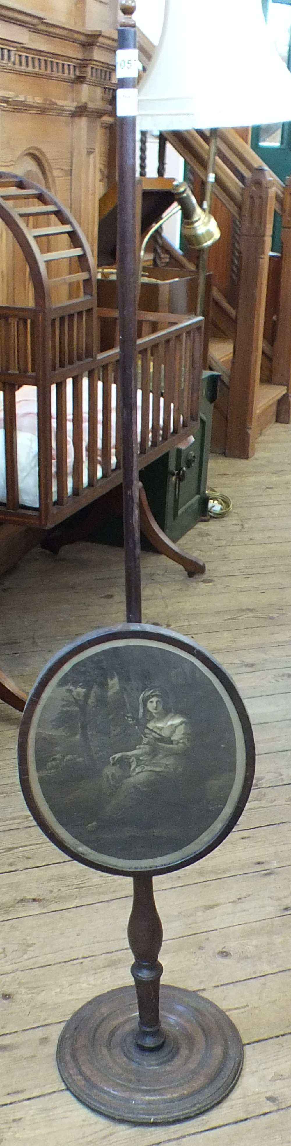 A 19th Century mahogany pole fire screen with oval screen