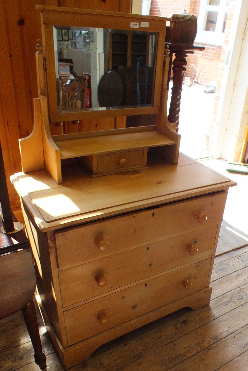 An Edwardian pine dressing chest of three drawers and mirrored top with single drawer