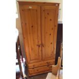 A pine wardrobe with two doors and two drawers