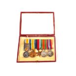 A cased group of five 'miniatures' mounted for wear including a WWI pair,