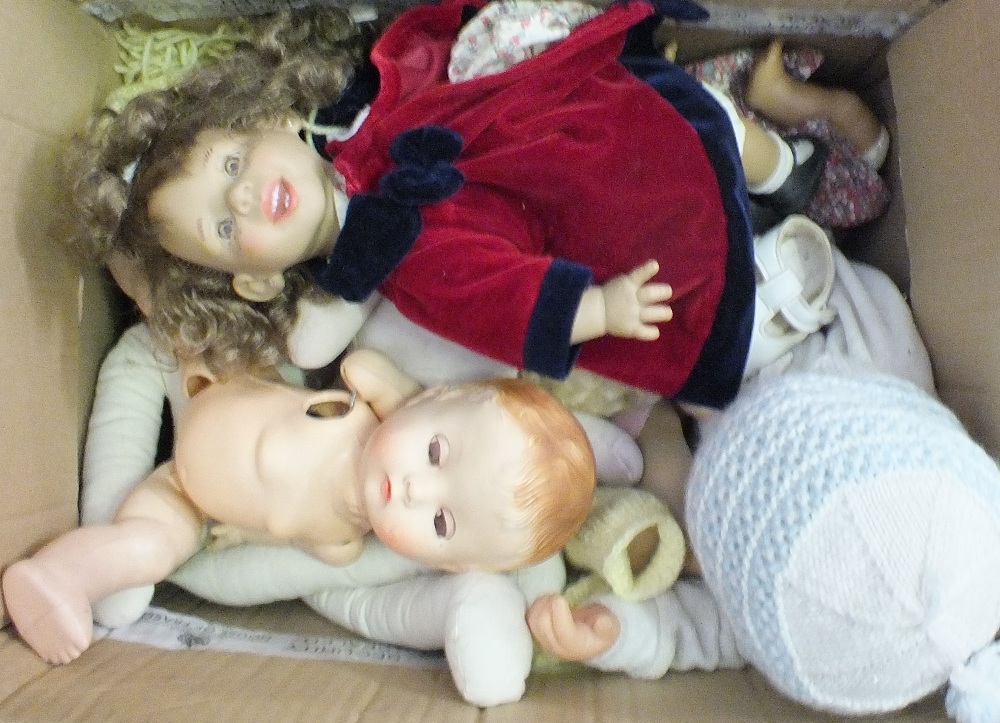 A box of various dolls