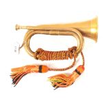 A brass bugle with lanyard