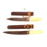 Two Burmese knives within their wire bound wooden sheaths