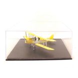 A model WWI Navy tin plate biplane with yellow livery and case