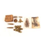 A mixed lot including military insignia, Naval cap tallies, buttons and inert 7.