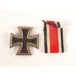 A German Third Reich era Iron Cross 1st class with pin back (some wear to central panels)