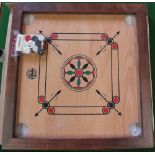 A wooden carrom board with counters