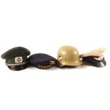 Three German (PATTERN) caps with a German (PATTERN) helmet