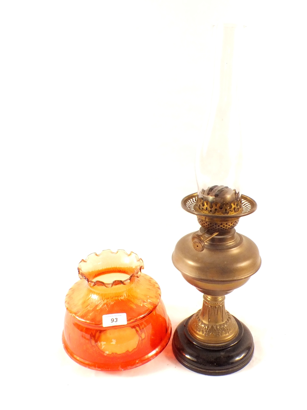 A brass column oil lamp with orange shade