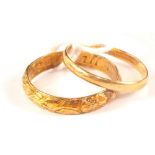 A small 18ct gold wedding band together with an unmarked yellow metal band with engraved decoration