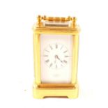 A miniature brass carriage clock, dial marked Pearce,