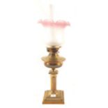 A brass column oil lamp with etched glass shade