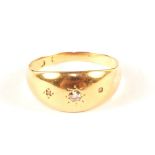 A yellow metal ring set with three small diamonds,